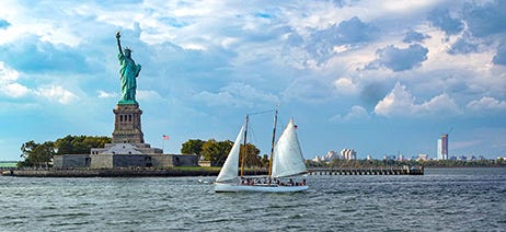 Sailboat next to Liberty Island in New York