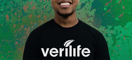 Male budtender wearing a Verilife t-shirt in front of a green background